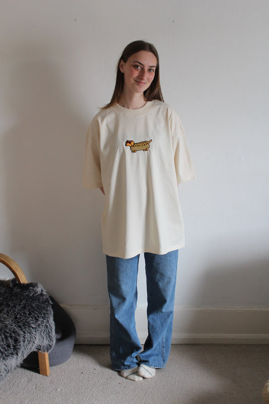Model wearing oversized sausage dog tee in natural raw – limited edition unisex streetwea